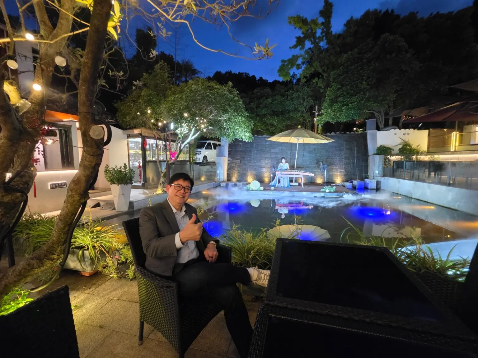 An intimate evening performance beside a pool